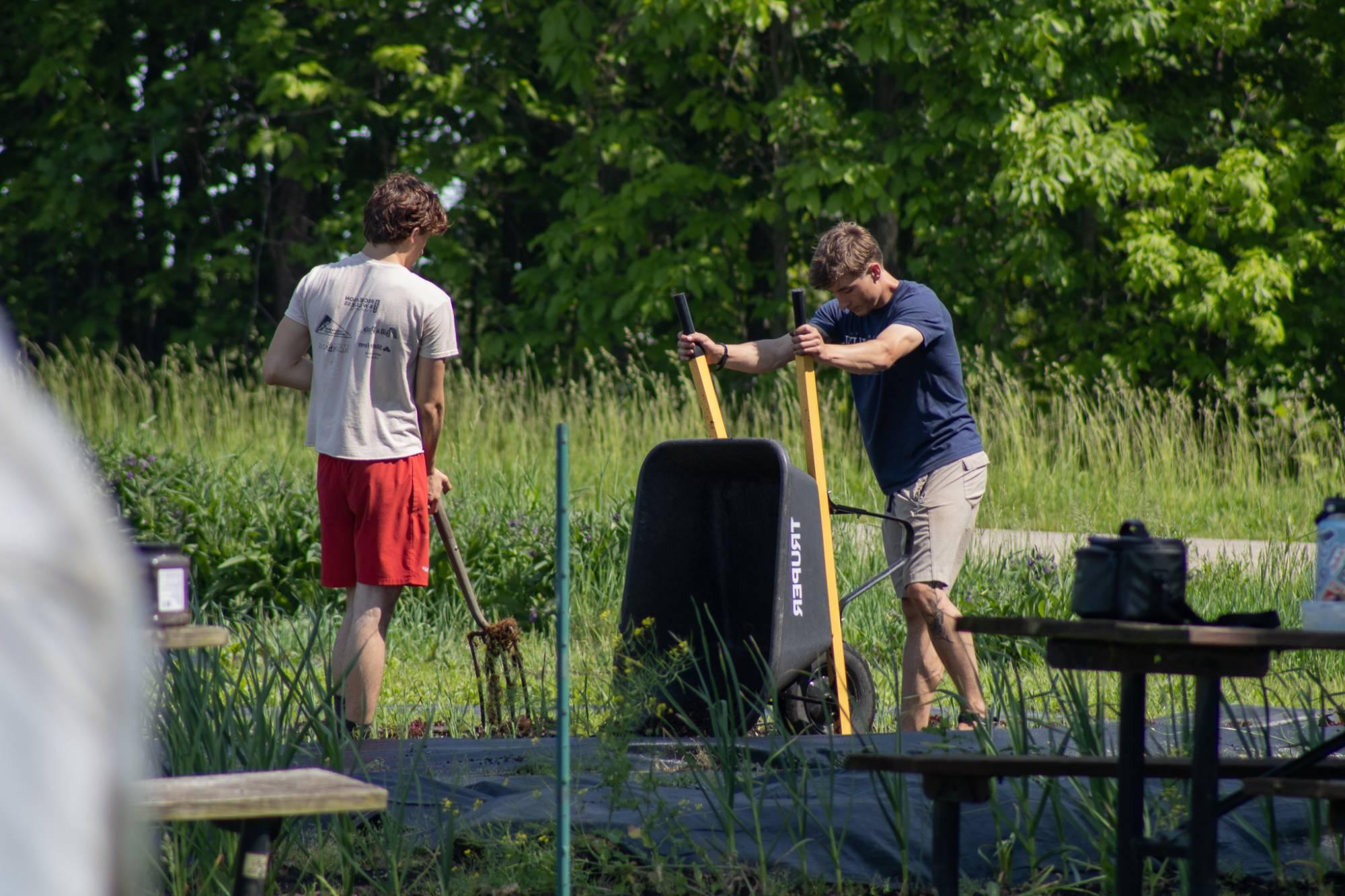 Farm crew members adding woodchips to the south field.